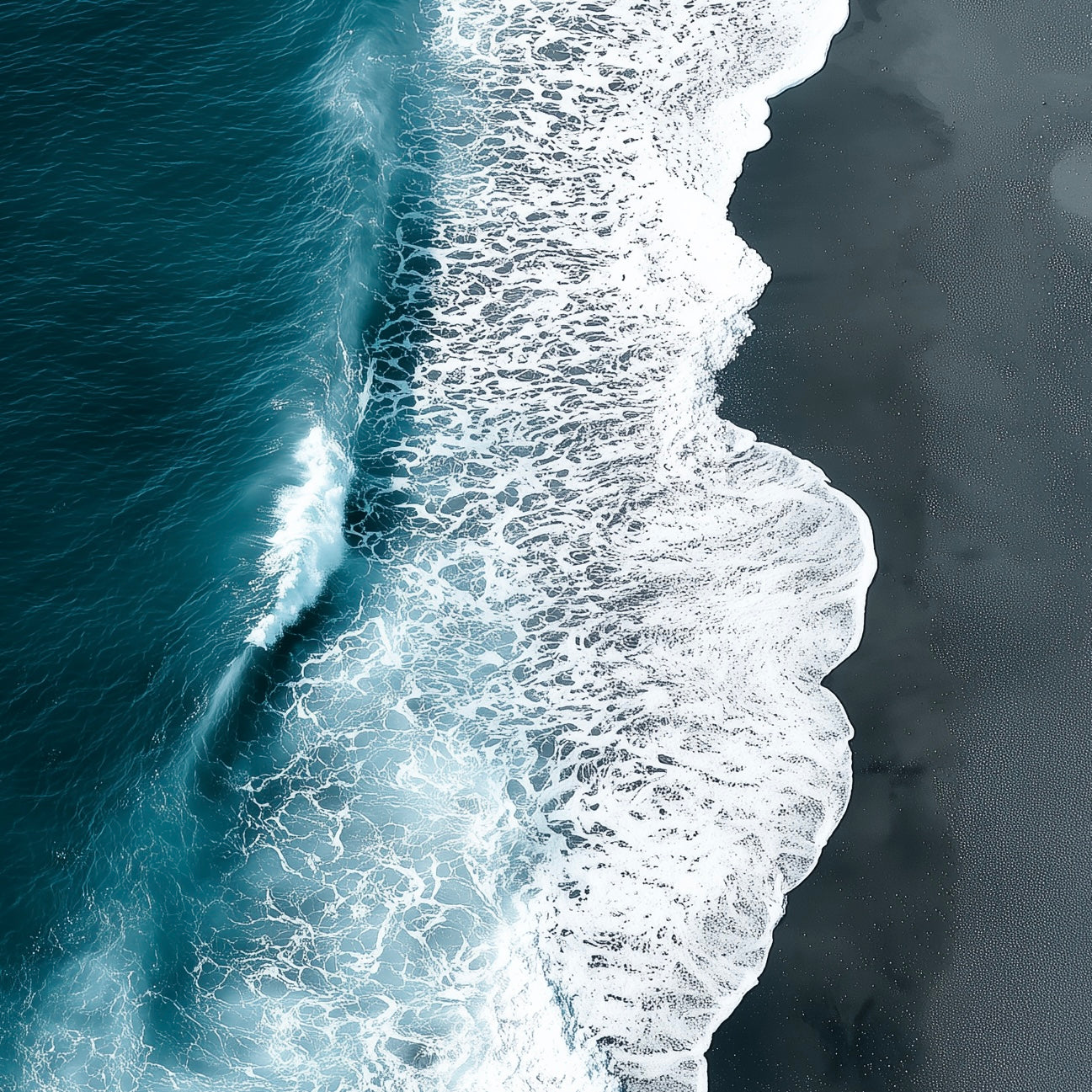 Close-up detail of A2 seascape print with black sand and shoreline waves.