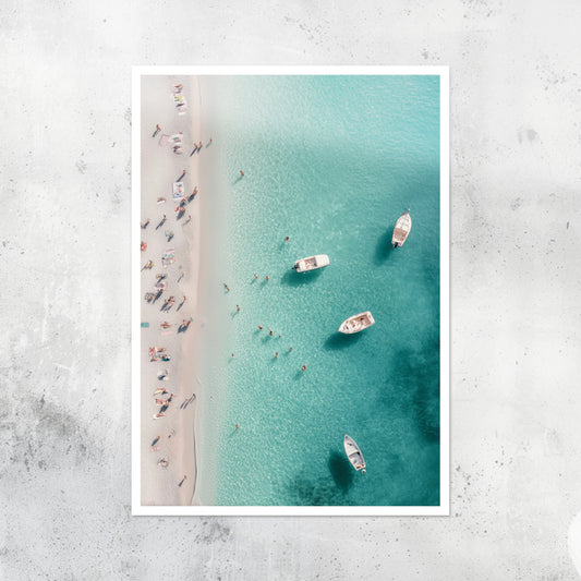 Unframed A2 artwork of an Italian beach with soft sea tones and sun-drenched rocks.
